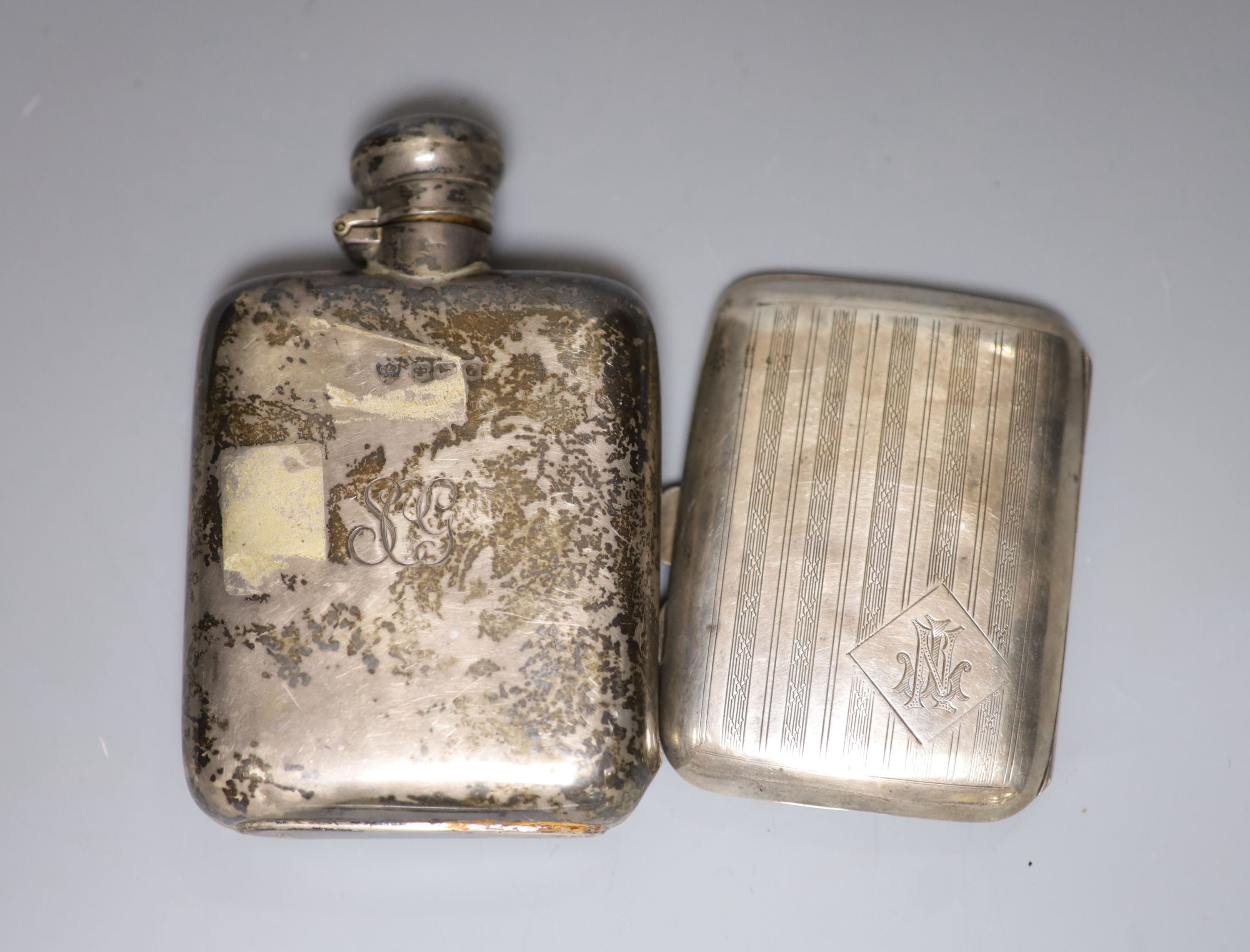 A silver shaped rectangular inkstand, fitted a silver-mounted cut glass bottle, a silver hip flask, engine-turned cigarette case and two ashtrays 13.5oz approximately